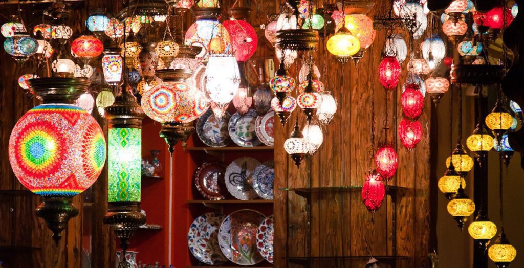 Colorful Mosaic Lamps and Hand-Painted Plates Display in a Cozy Setting.