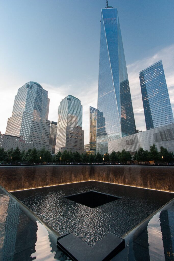 9/11 Memorial and One World Trade Center tower: symbolizing resilience and reflection in NYC.