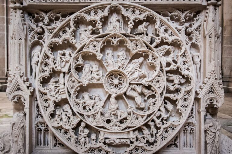 Intricate Gothic cathedral stone carving with detailed rosette and ornate borders.