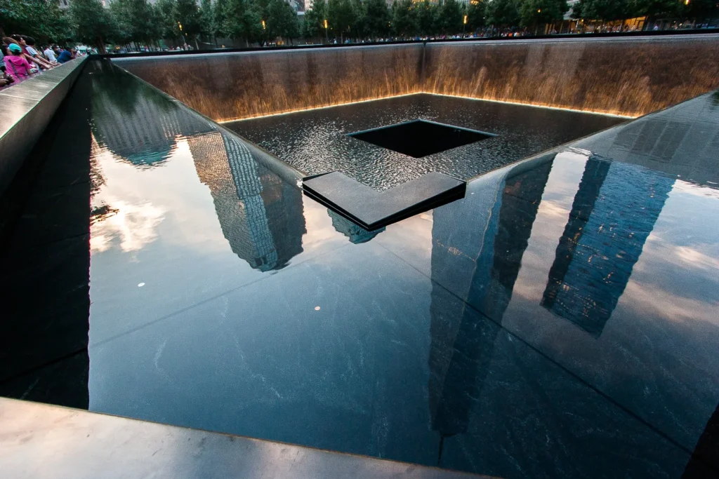 September 11 Memorial North Pool: Reflective tribute with cascading water, surrounded by visitors.
